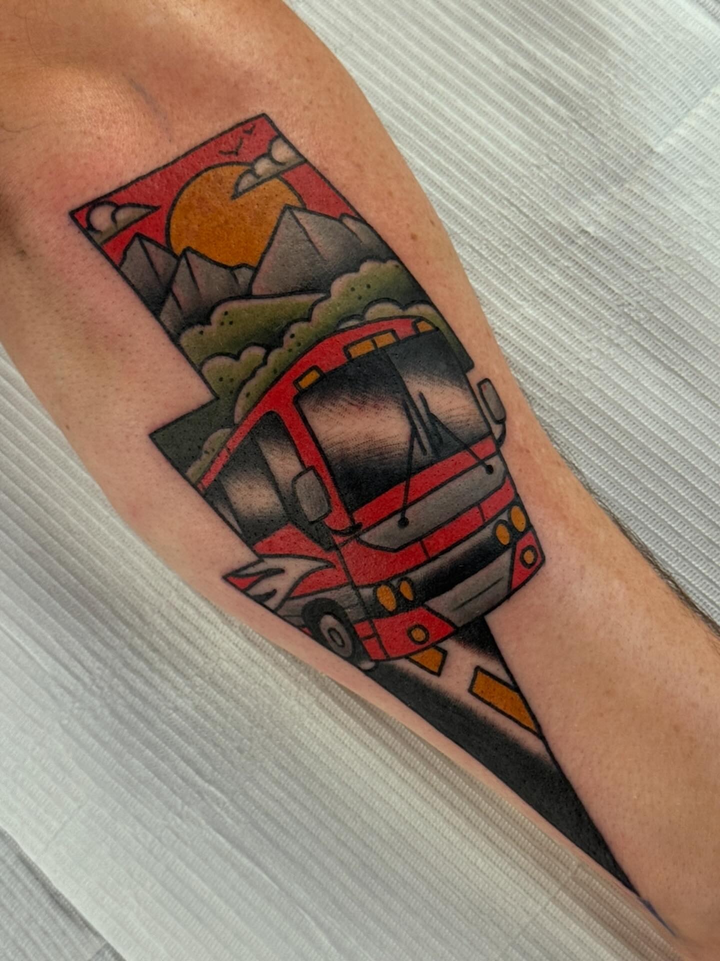 Bus American traditional tattoo on the forearm by Cory Craft