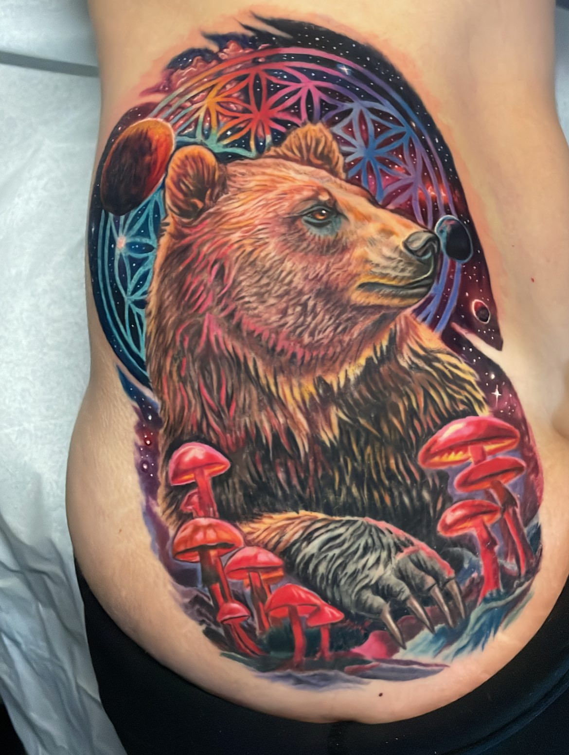 Bear realism tattoo on the ribs by Rick Elliott