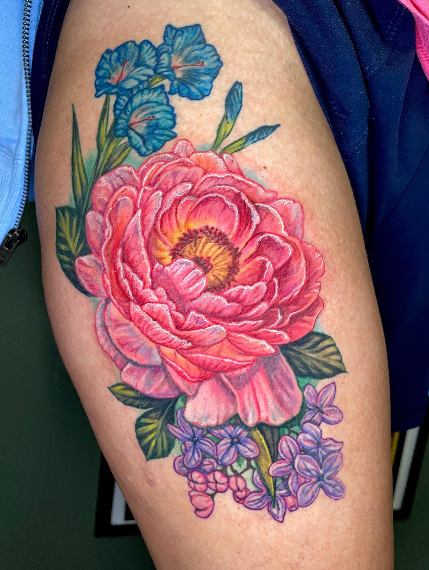 Peony and flowers realism tattoo on the thigh by Rick Elliott