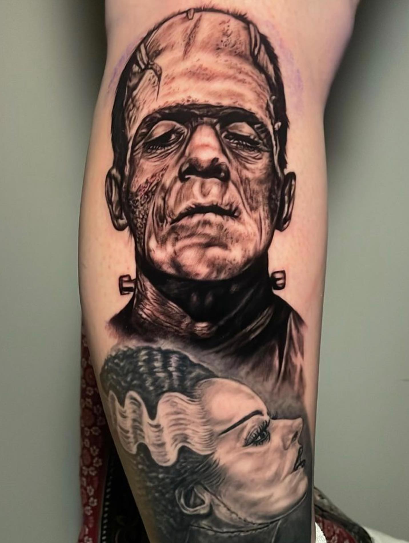 Frankenstein and Bride realism tattoo on the forearm by Rick Elliott