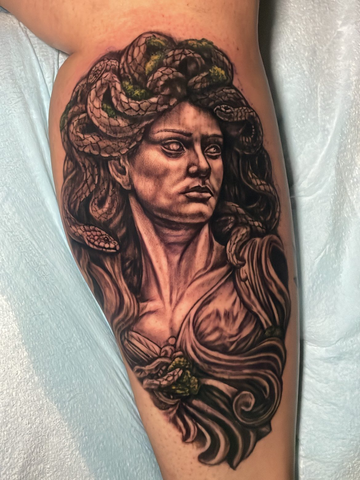 Medusa realism tattoo on the thigh by Rick Elliott