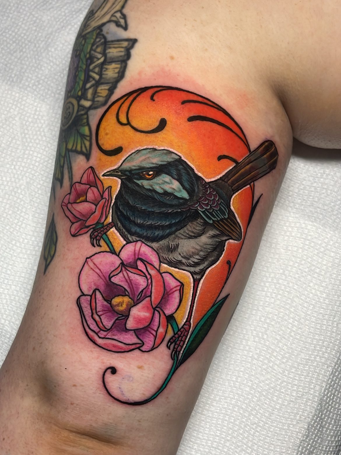 Bird and flowers American traditional tattoo on the forearm by Rick Elliott