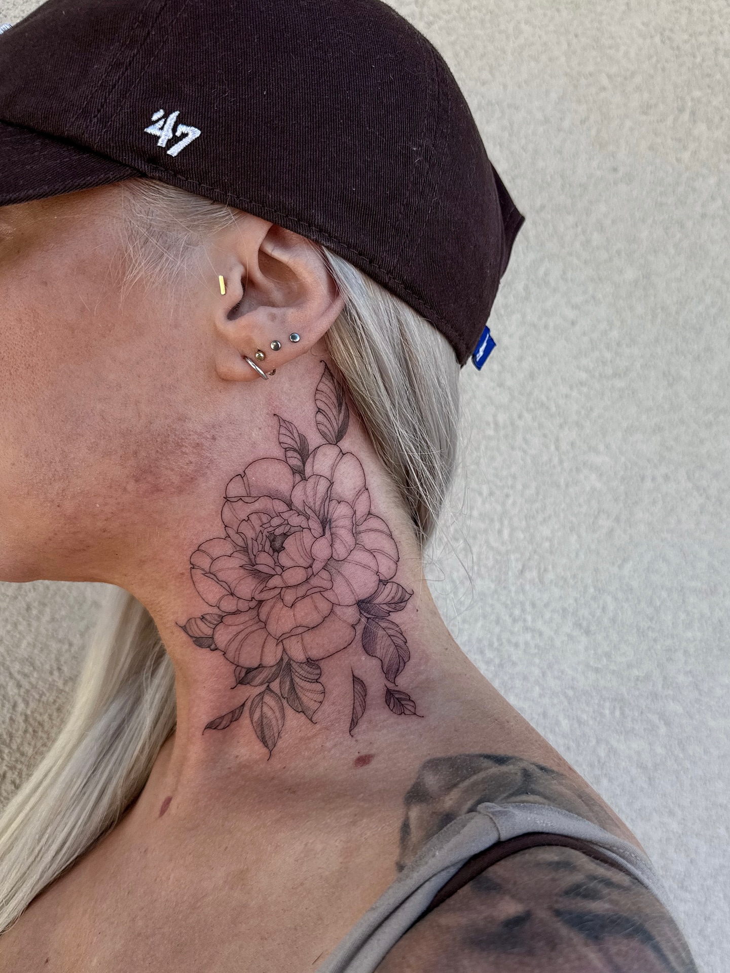 Peony black and grey tattoo on the neck by Abby Robinson