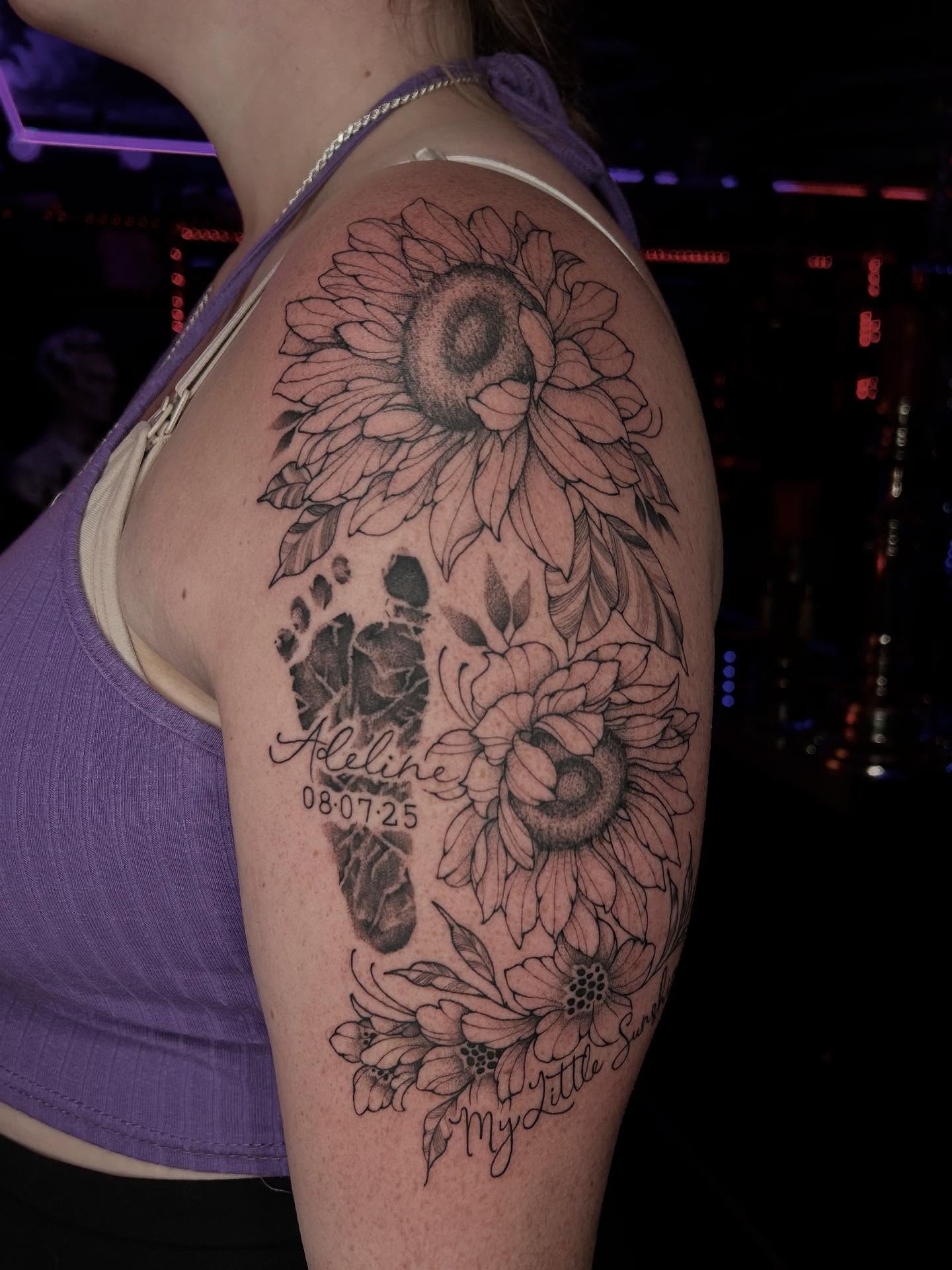 Sunflower and footprints realism tattoo on the shoulder by Tattoos by Abbey