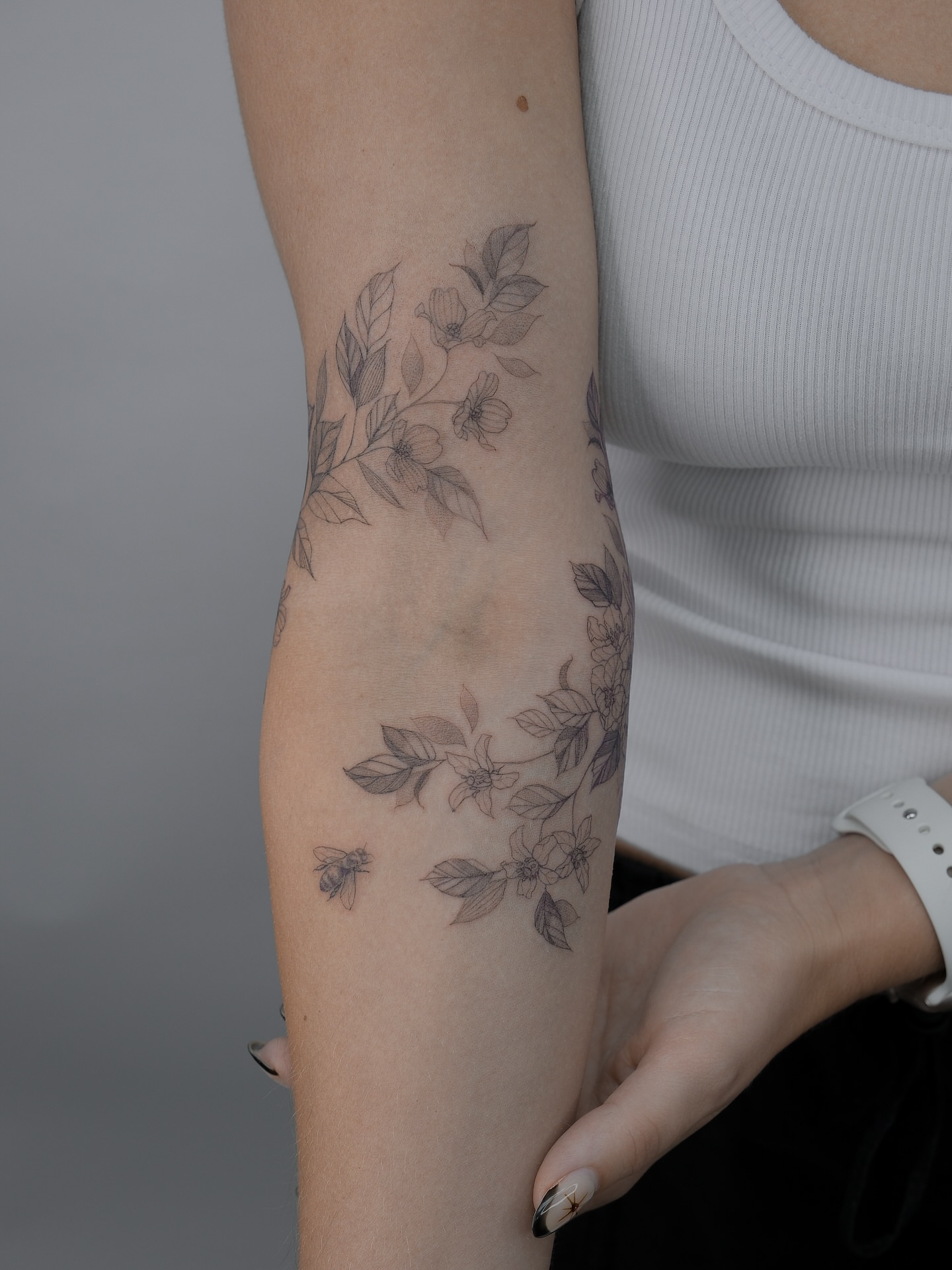 Flower and bee black and grey tattoo on the forearm by Tattoo in Charlotte NC, Charlotte, North Carolina