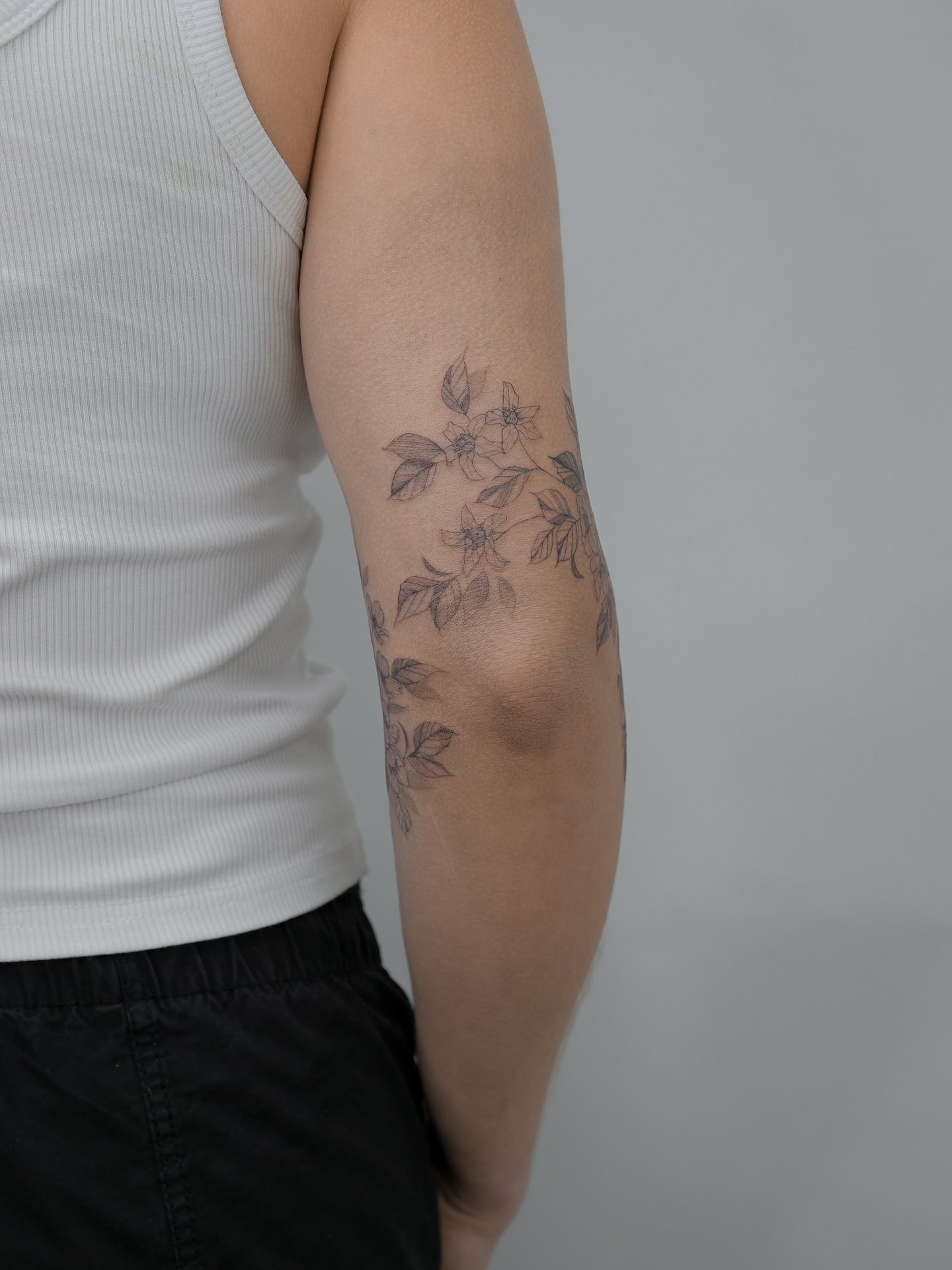 Floral arrangement black and grey tattoo on the forearm by Tattoo in Charlotte NC, Charlotte, North Carolina