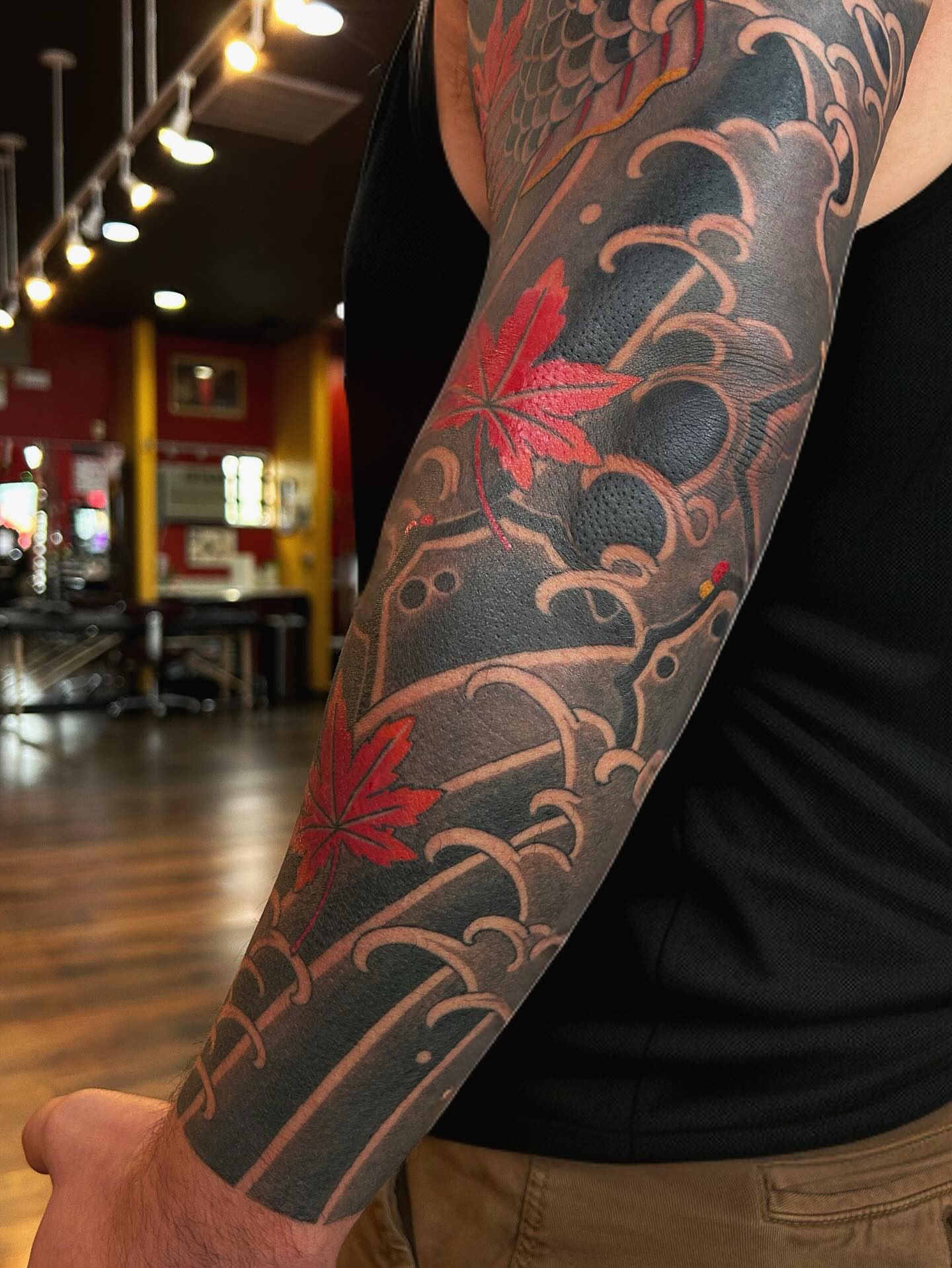 Maple leaves and waves japanese irezumi tattoo on the forearm by Tako, Seattle, Washington