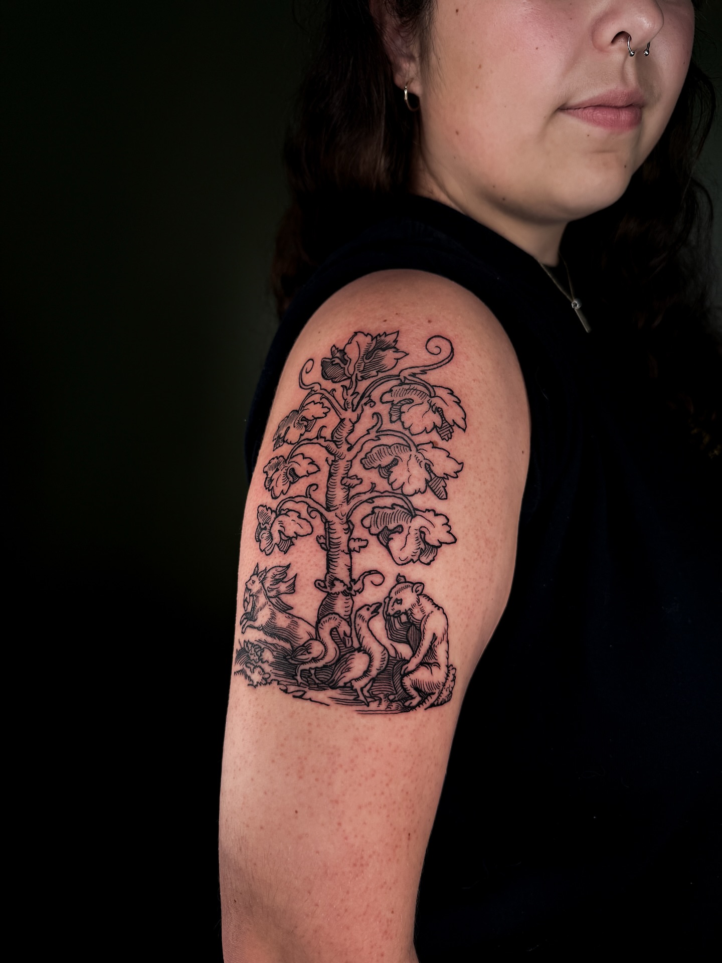 Tree with bears black and grey tattoo on the upper arm by Zella Mäkelä