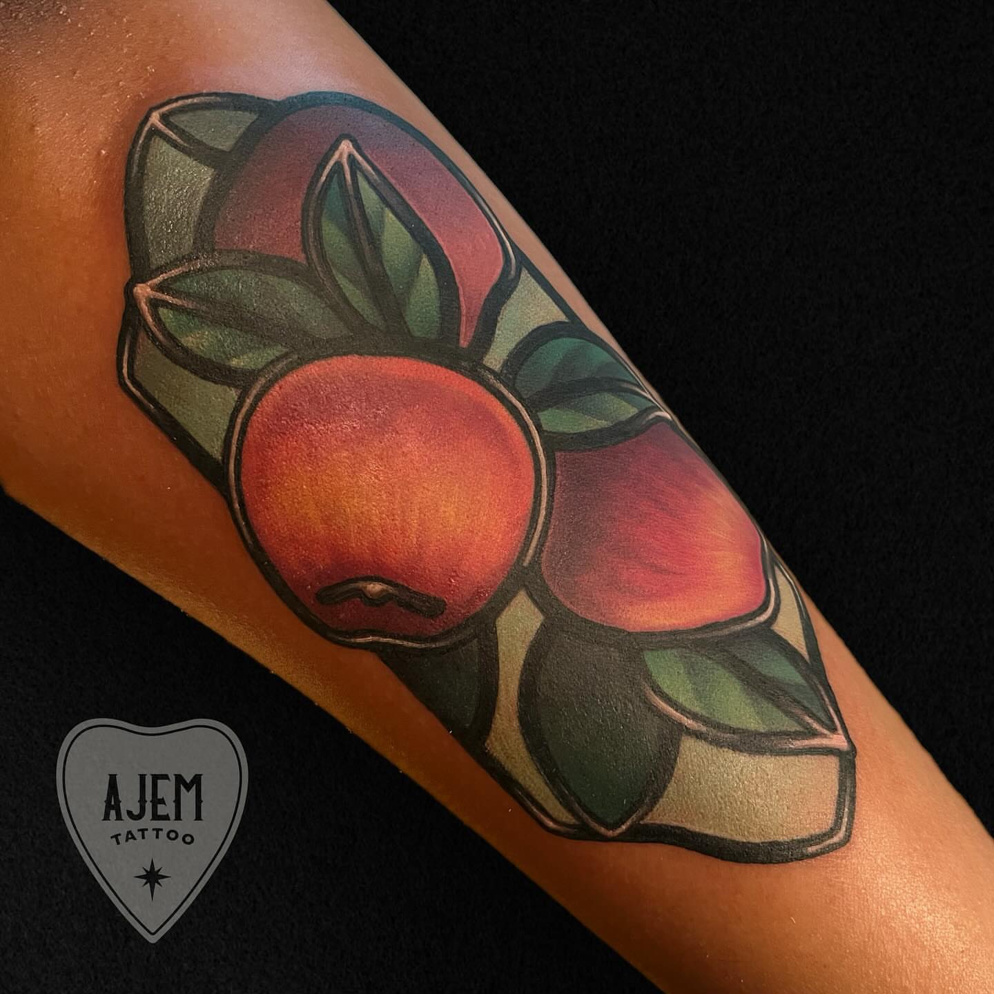 Peach and leaves American traditional tattoo on the forearm by Ash MacIsaac