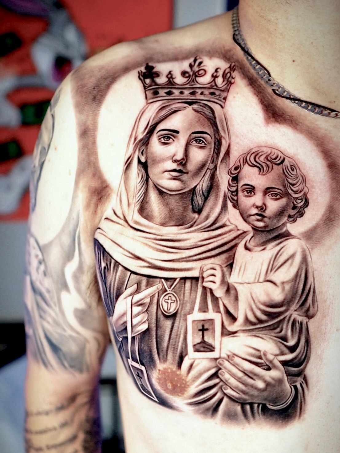 Religious figure with child realism tattoo on the chest by Artfabn