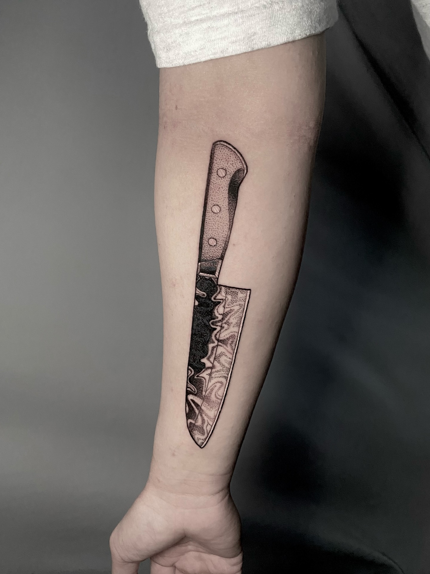 Knife dotwork tattoo on the forearm by Rowan Starr