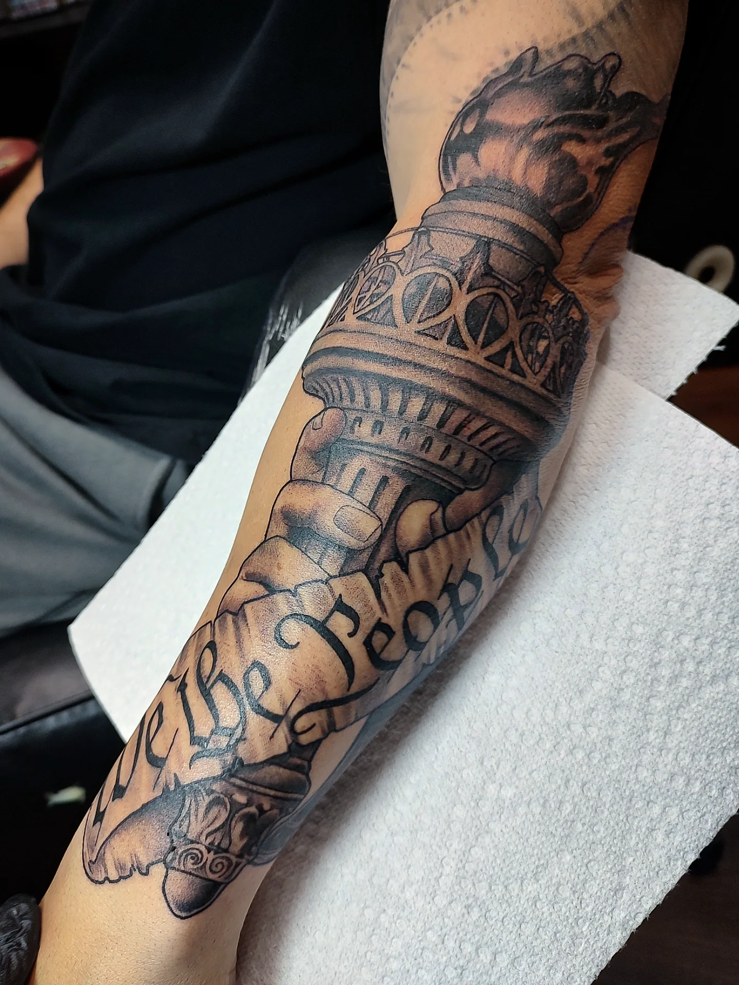 Statue of liberty black and grey tattoo on the forearm by Jennifer Fowler
