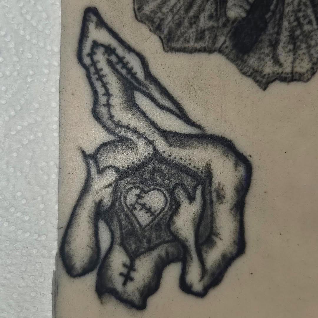 Stitched rabbit with heart sketch tattoo on the forearm by π«