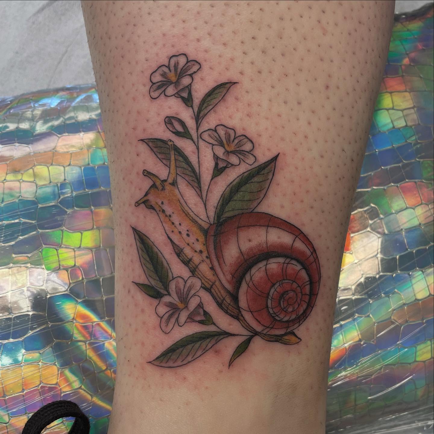 Snail and flowers realism tattoo on the forearm by Dayton Tattoo Artist, Miamisburg, Ohio