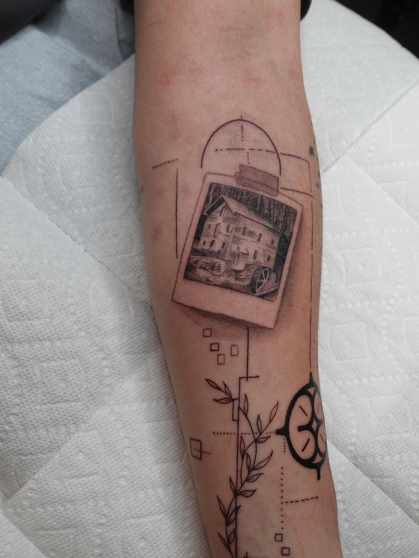 Polaroid house realism tattoo on the forearm by Tat by Brendan