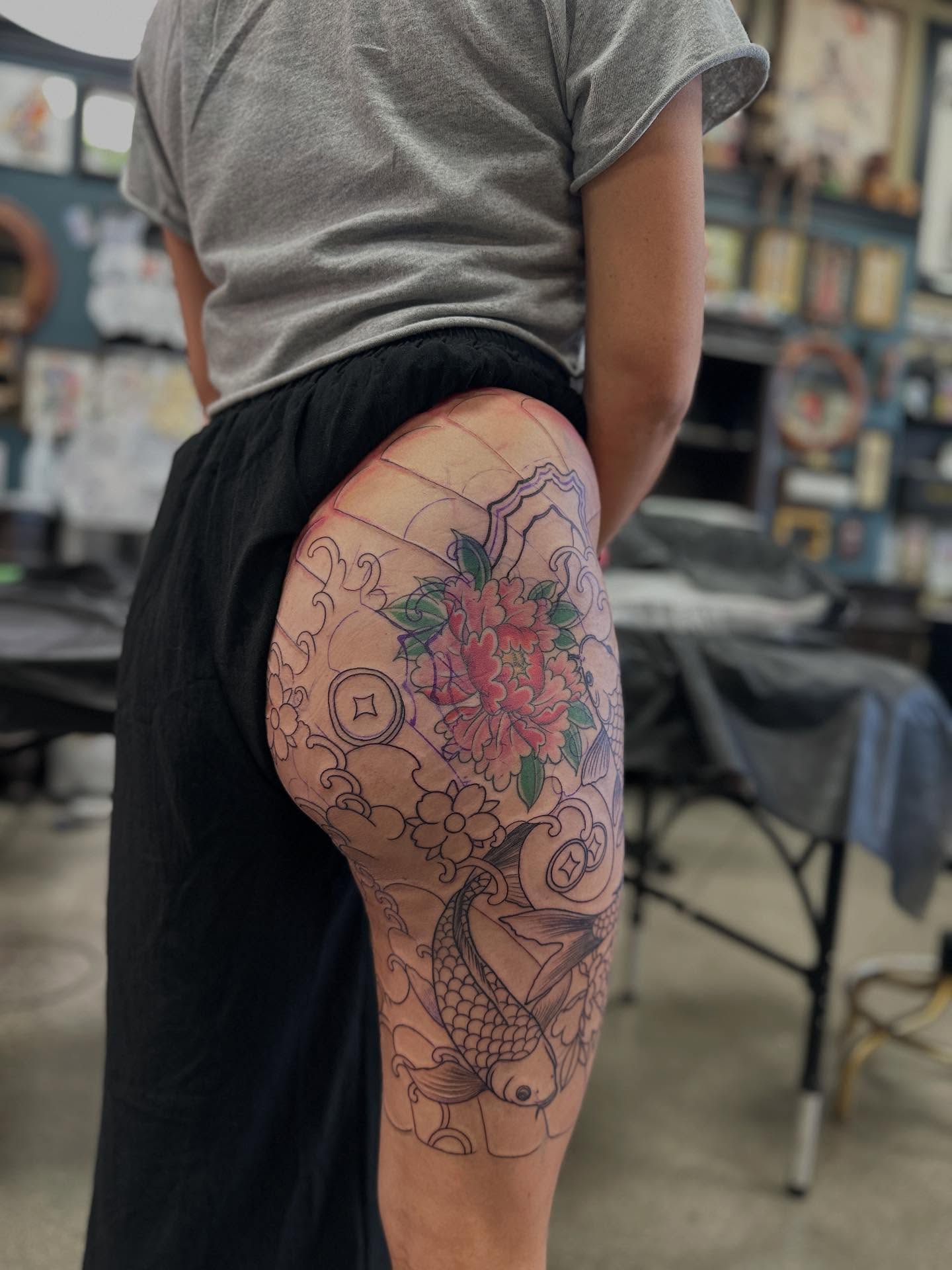Koi fish and floral japanese irezumi tattoo on the thigh by Shawn Feng