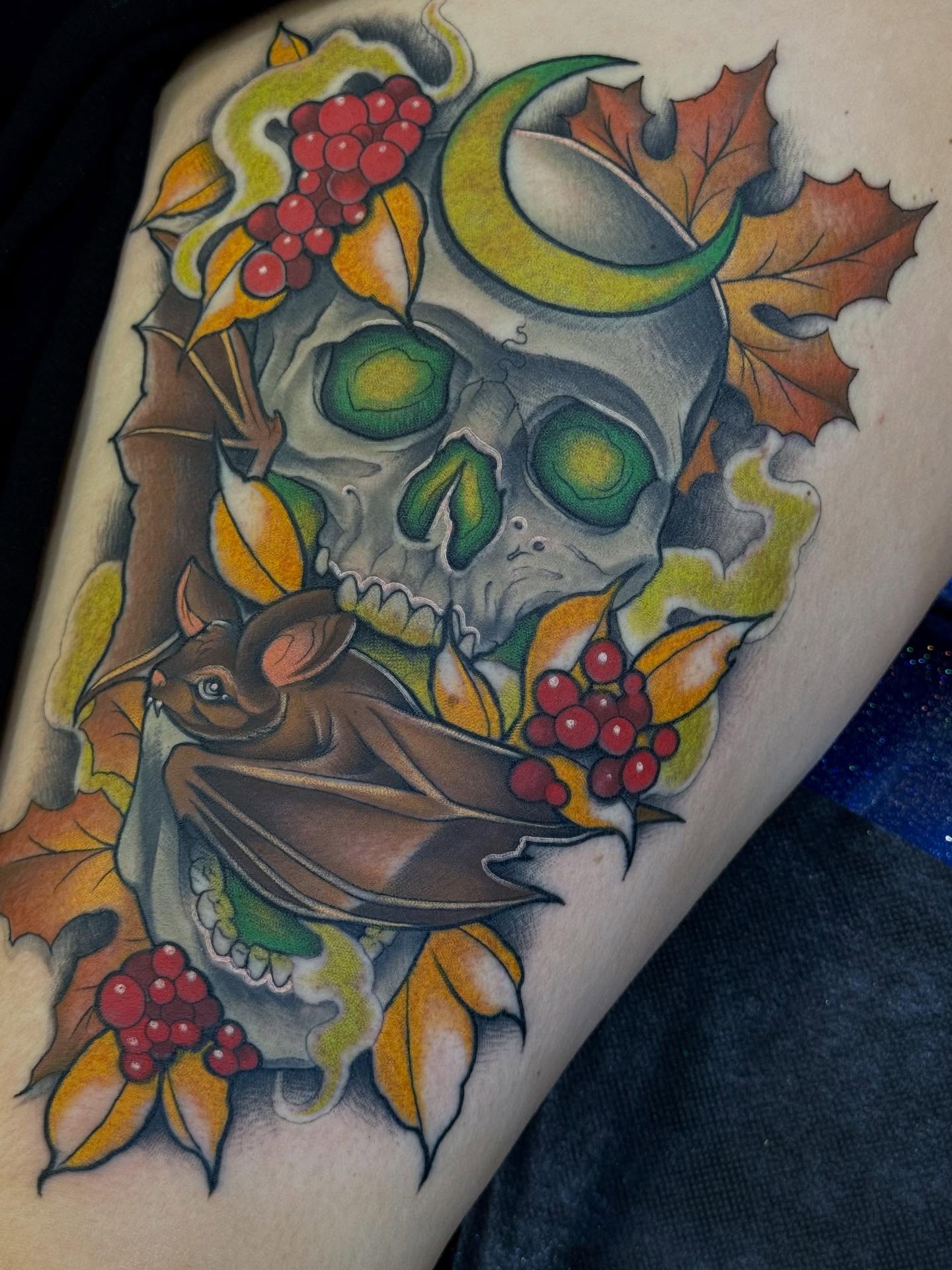 Skull with autumn leaves American traditional tattoo on the thigh by Espinal