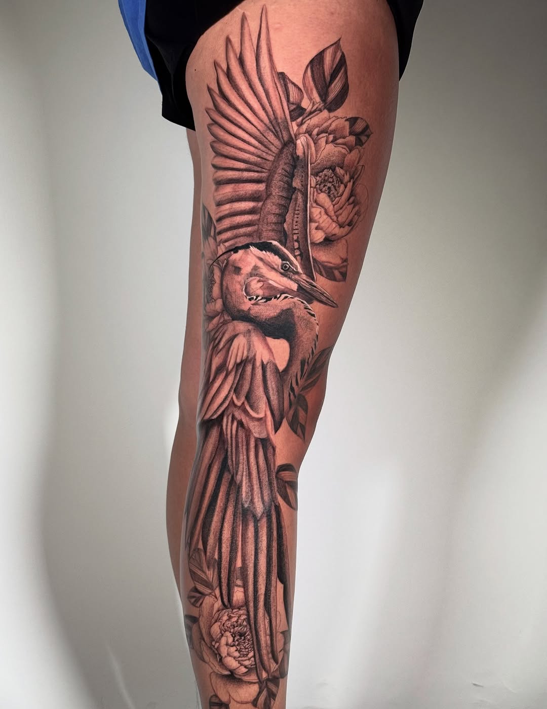 Heron and peonies fine line tattoo on the leg by Brisia Cisneros
