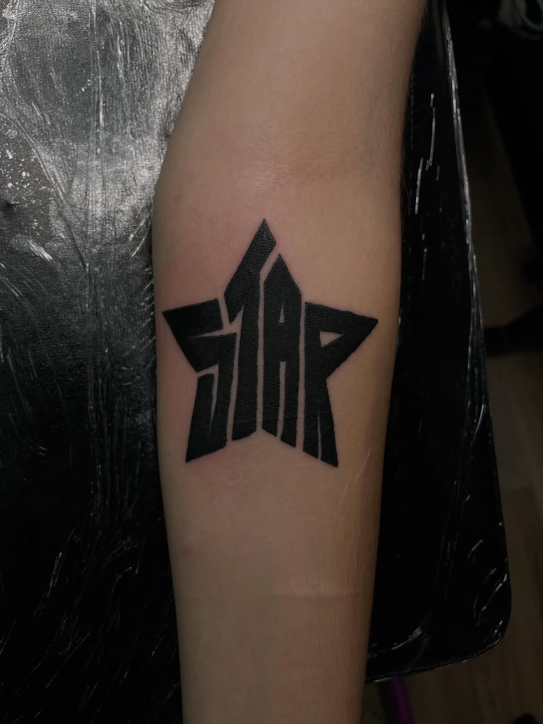Star with lettering cyber sigilism tattoo on the forearm by ꧁༺𝔅𝔦𝔤 ℭ𝔥𝔲𝔫𝔤𝔲𝔷༻꧂, San Diego, California