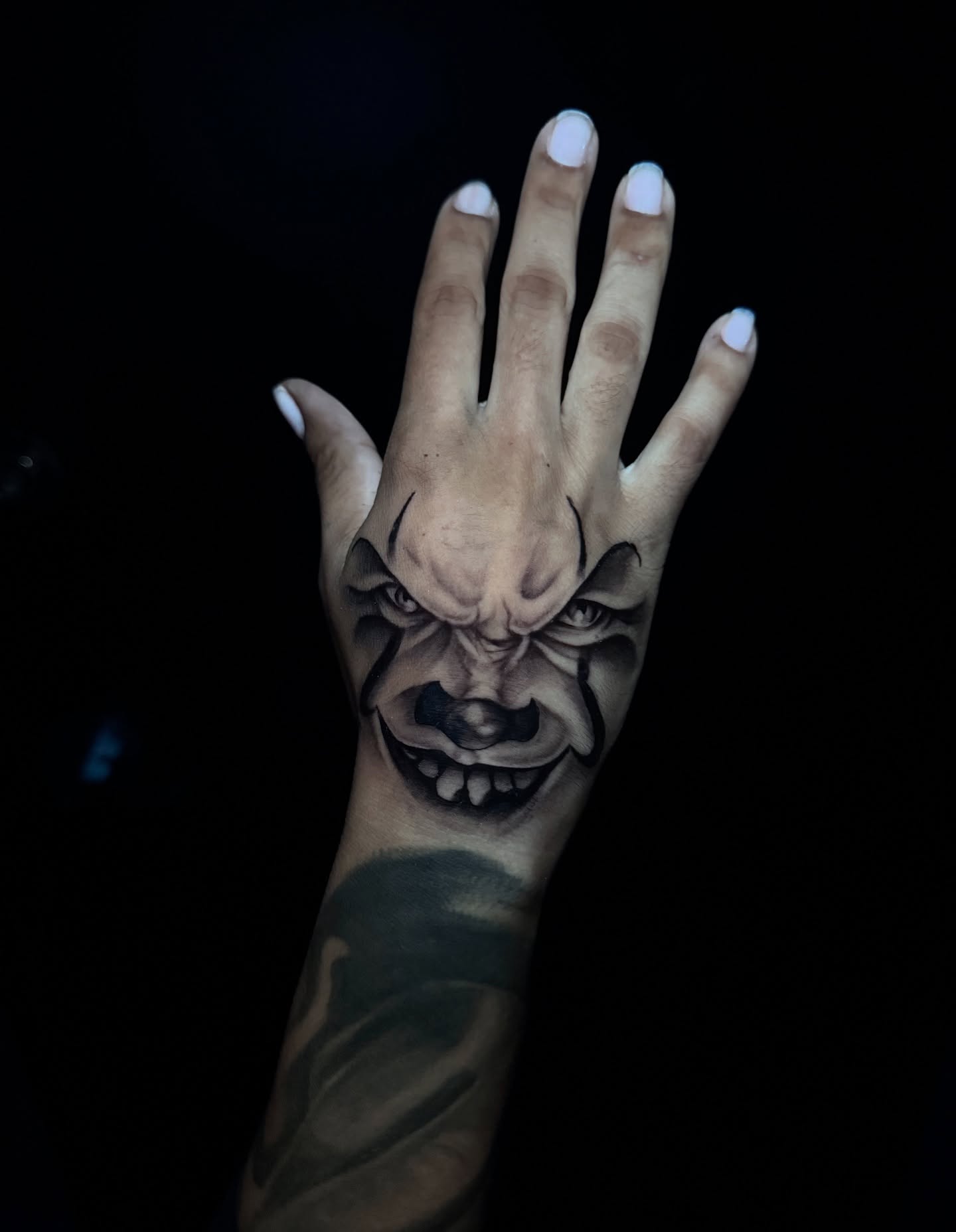 Joker face realism tattoo on the hand by Ryland - Tattoo Artist