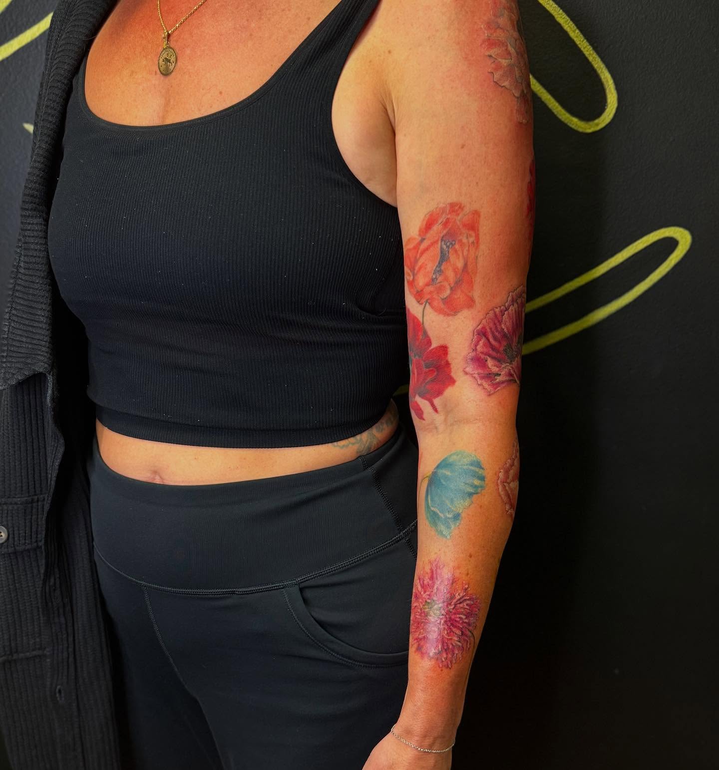 Flowers realism tattoo on the forearm by Tattoos By Trish