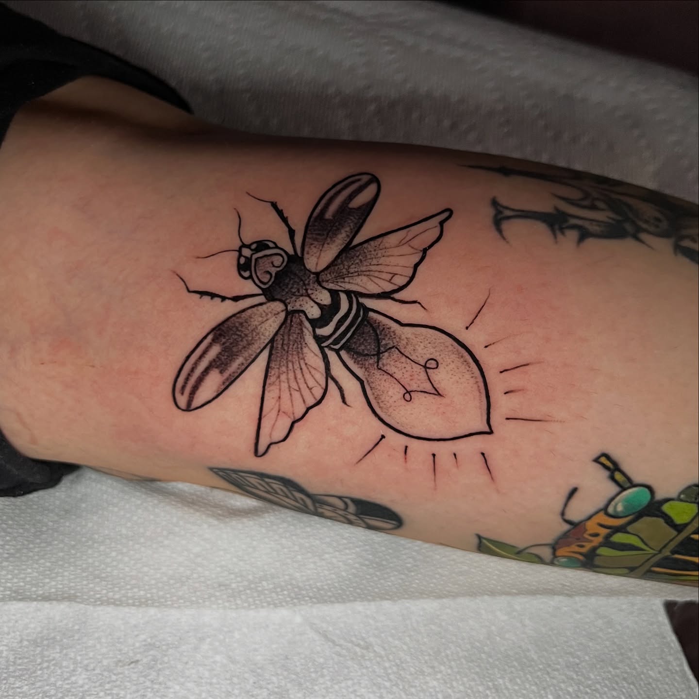 Bee and light bulb dotwork tattoo on the forearm by Nick Ochoa
