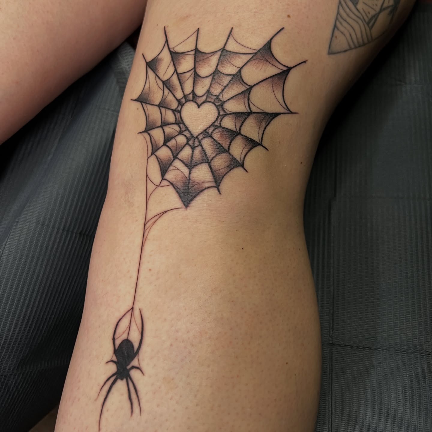 Spider web with heart geometric tattoo on the forearm by Nick Ochoa