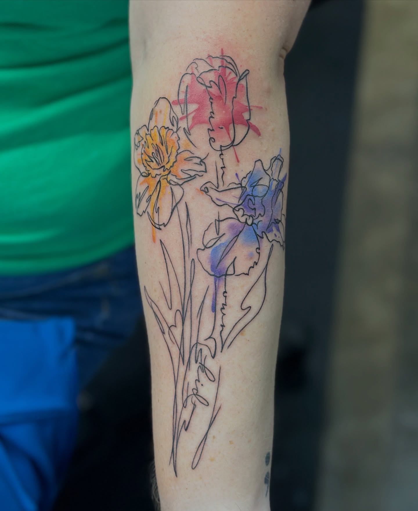 Watercolor flowers watercolor tattoo on the forearm by Megan Sierra