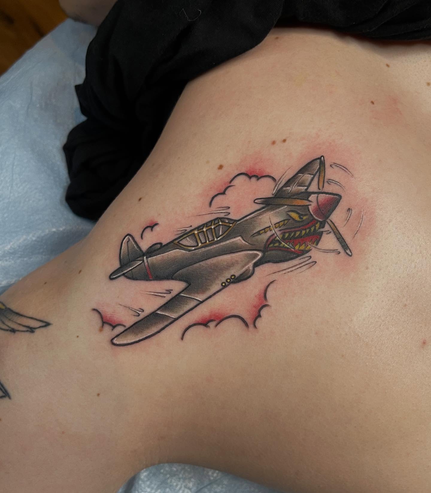 Fighter plane American traditional tattoo on the shoulder by Allison Gallagher