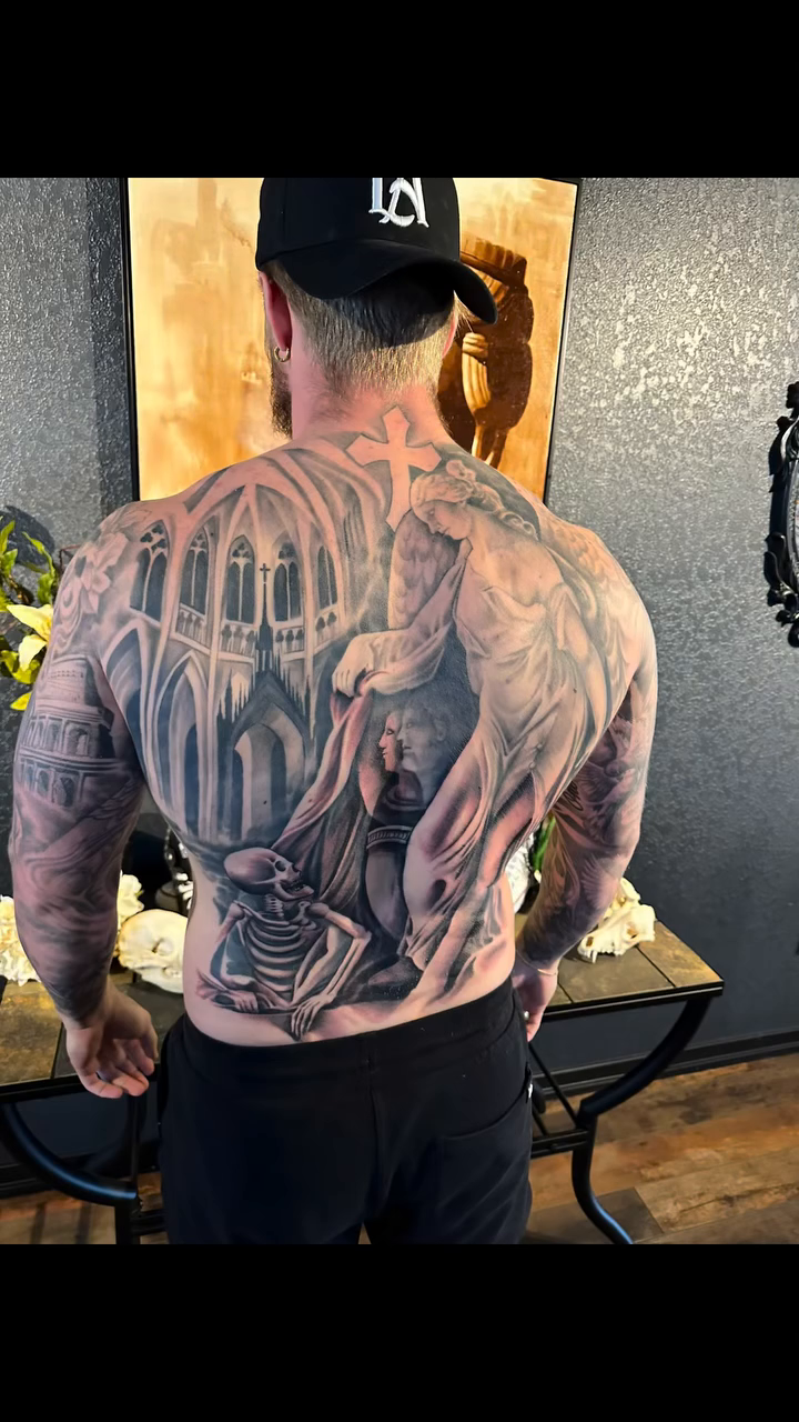 Angels and skeletons in a cathedral realism tattoo by Jason Oz, Denver, Colorado