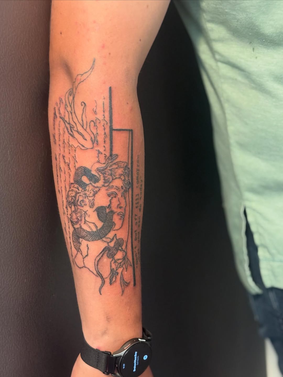 Medusa head with snake and script sketch tattoo on the forearm by sams tattoos