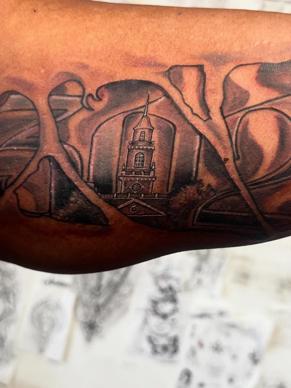 Tower in landscape black and grey tattoo on the forearm by Eldaddy