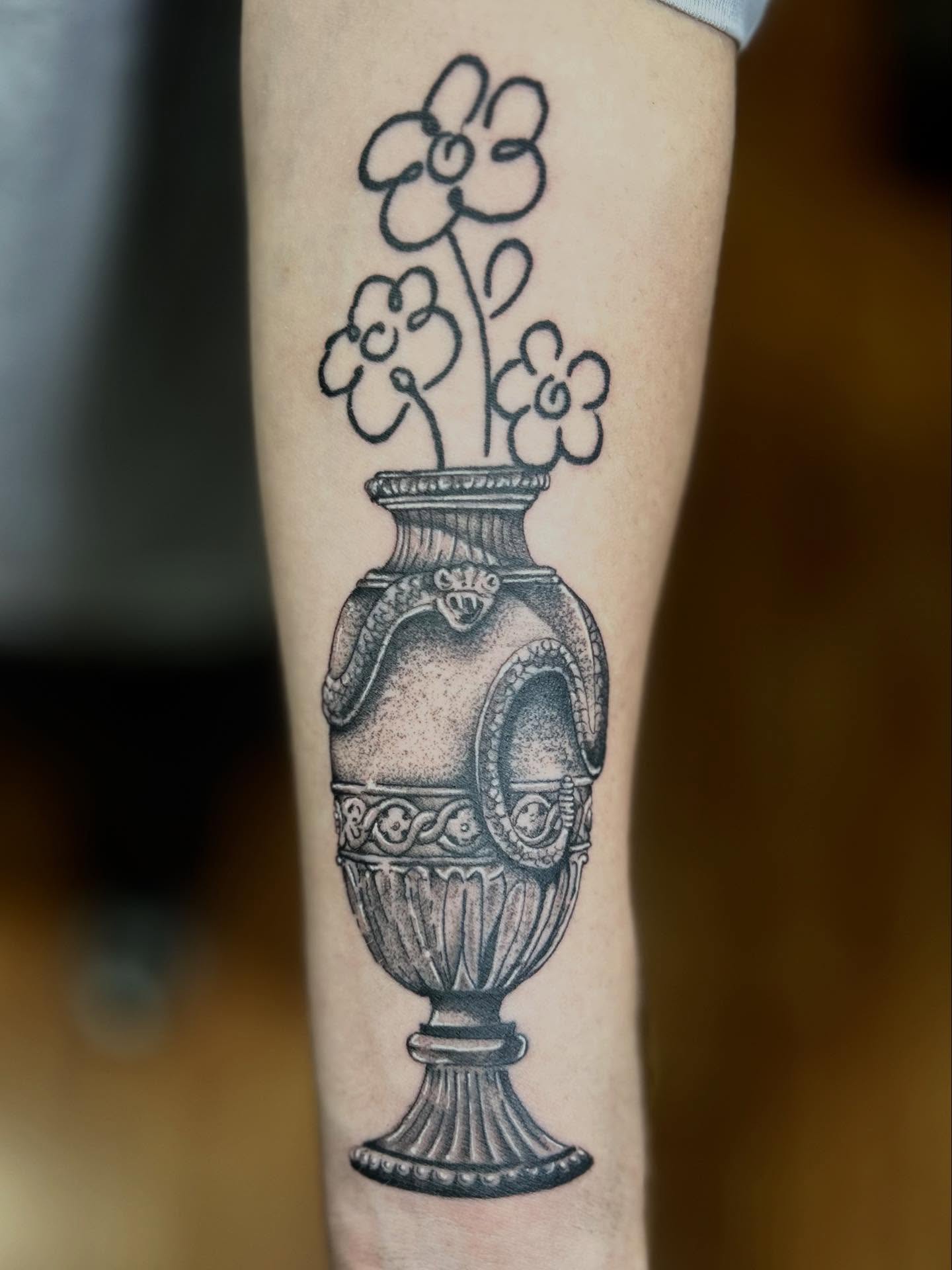 Vase with flowers black and grey tattoo on the forearm by Barro