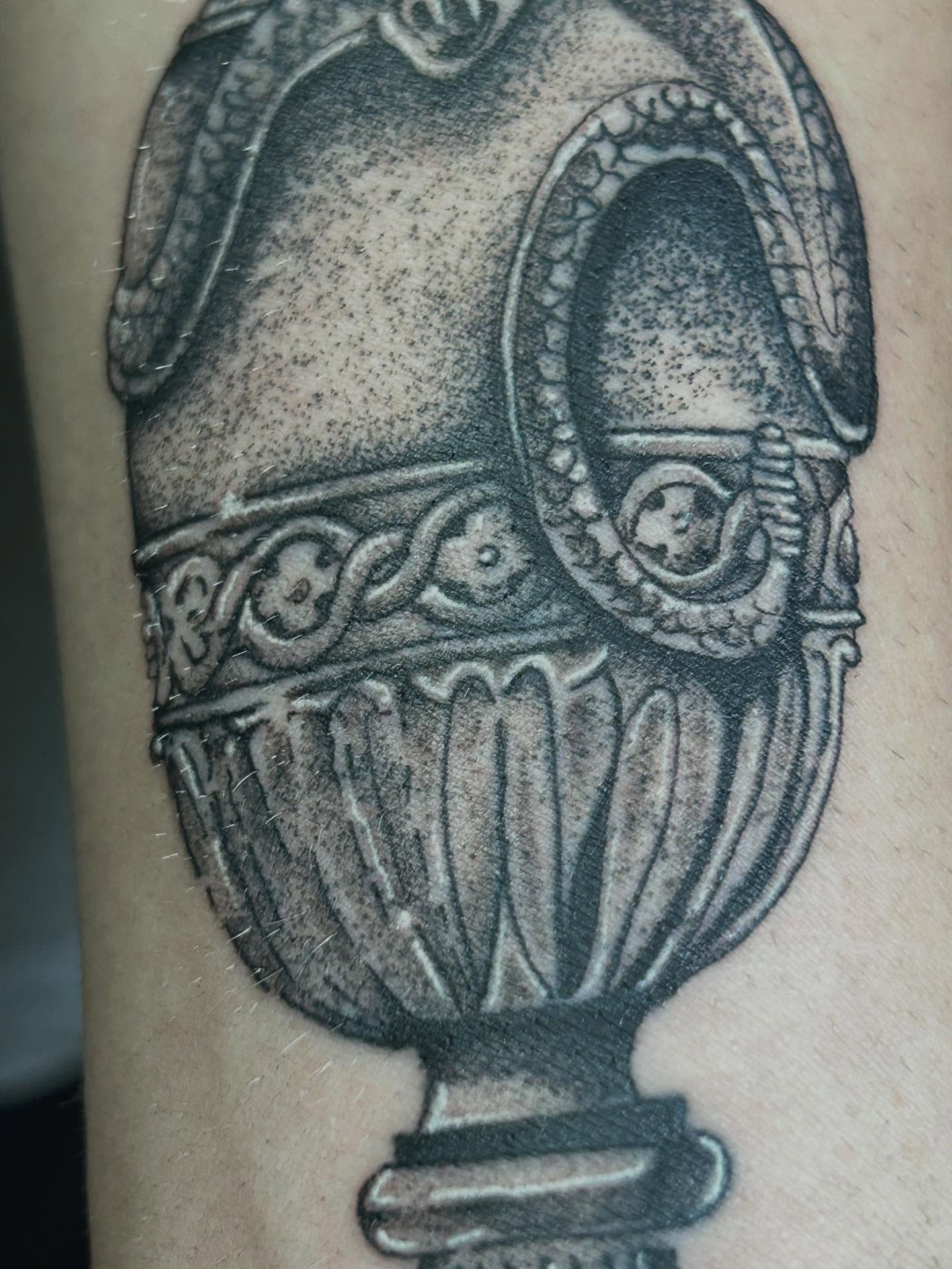 Urn black and grey tattoo on the forearm by Barro