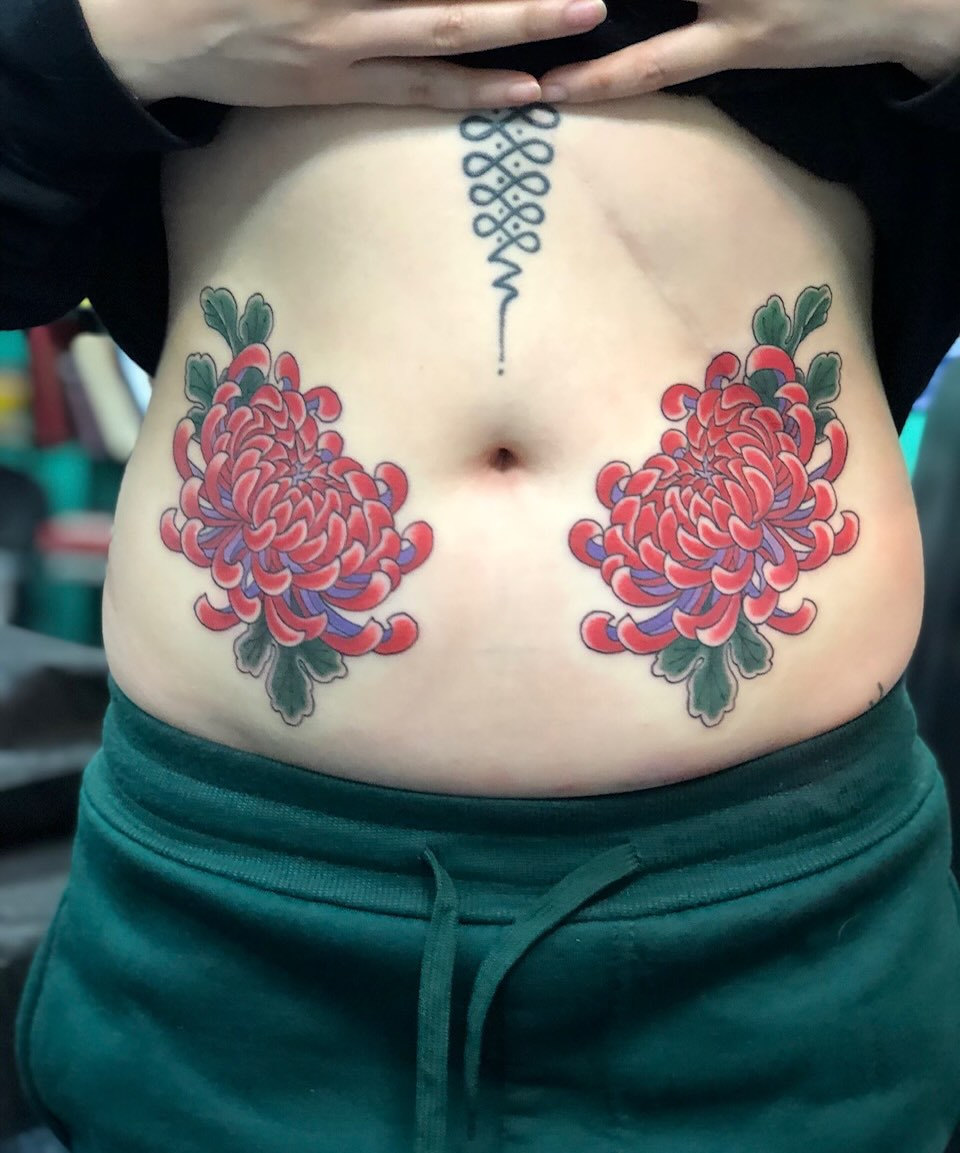 Chrysanthemums American traditional tattoo on the torso by Matt Klass