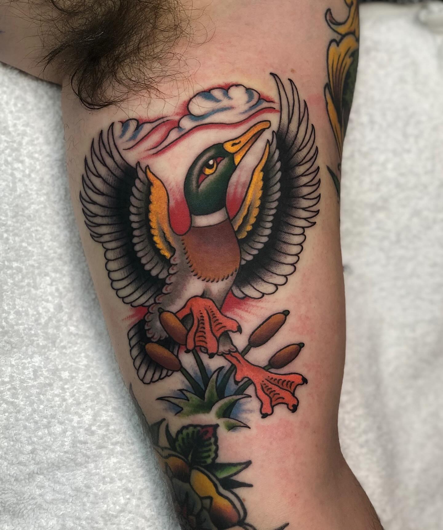 Ducks and flowers American traditional tattoo on the forearm by Matt Klass