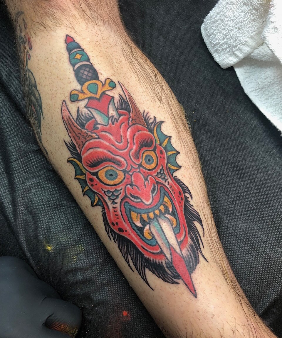 Demon mask with sword American traditional tattoo on the forearm by Matt Klass