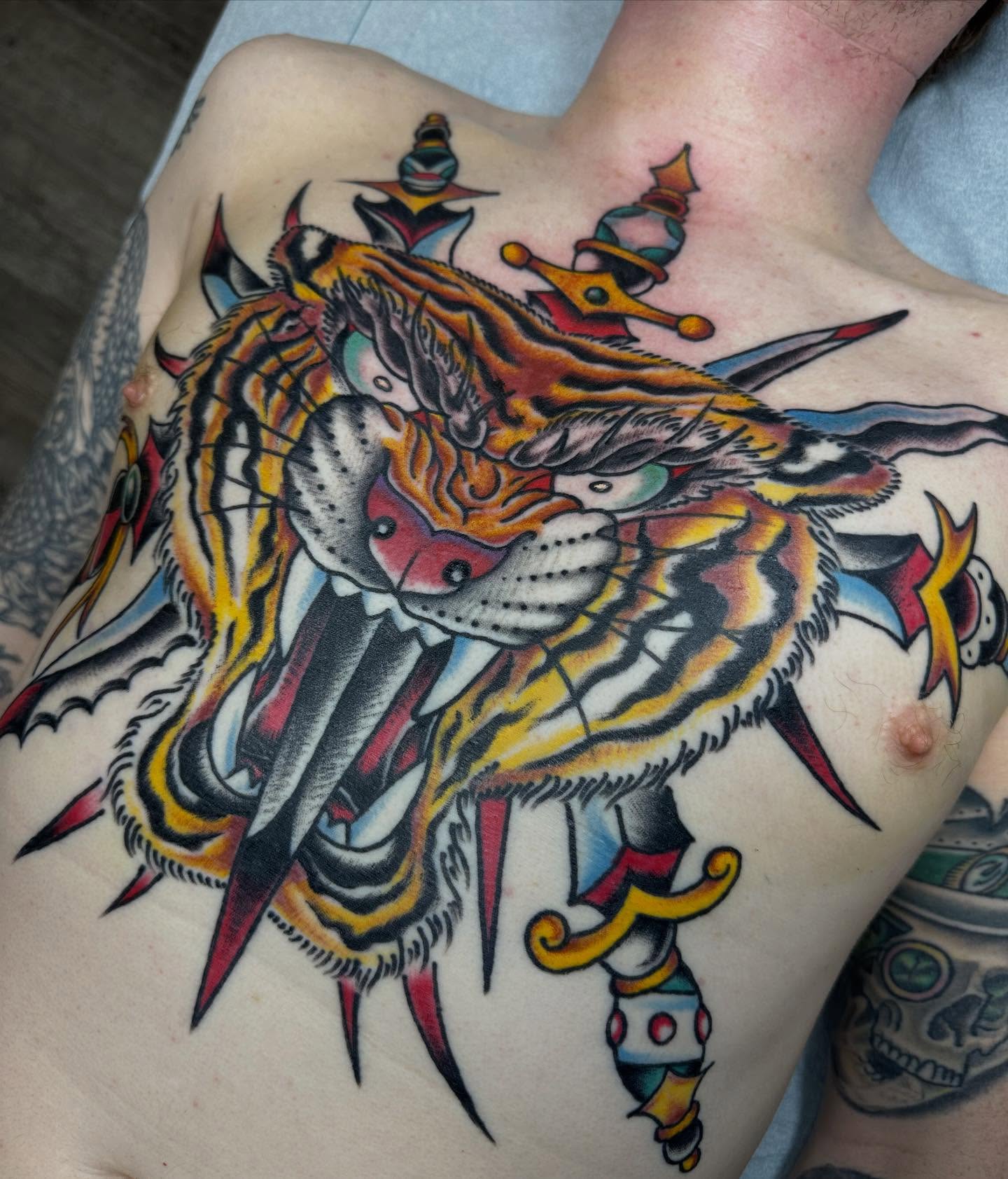 Tiger American traditional tattoo on the chest by Devin Spenny
