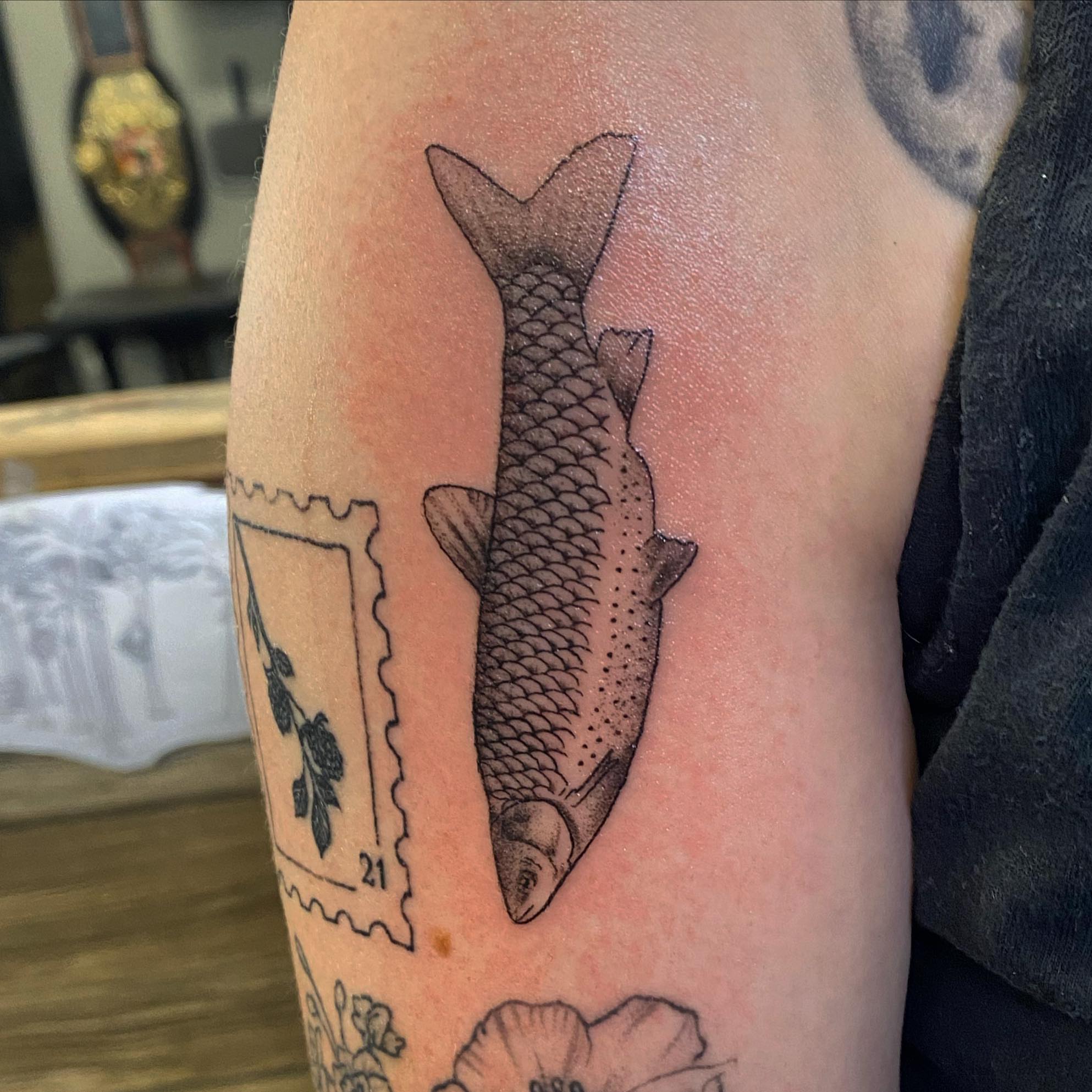 Fish black and grey tattoo on the forearm by Spencer Jones Tattoos