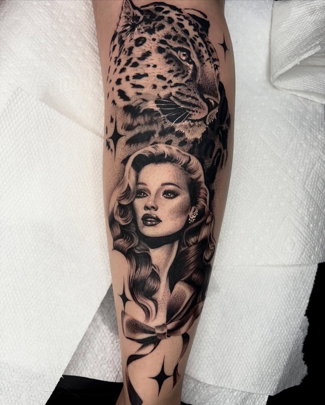 Leopard and woman portrait realism tattoo on the forearm by Avery Mullins