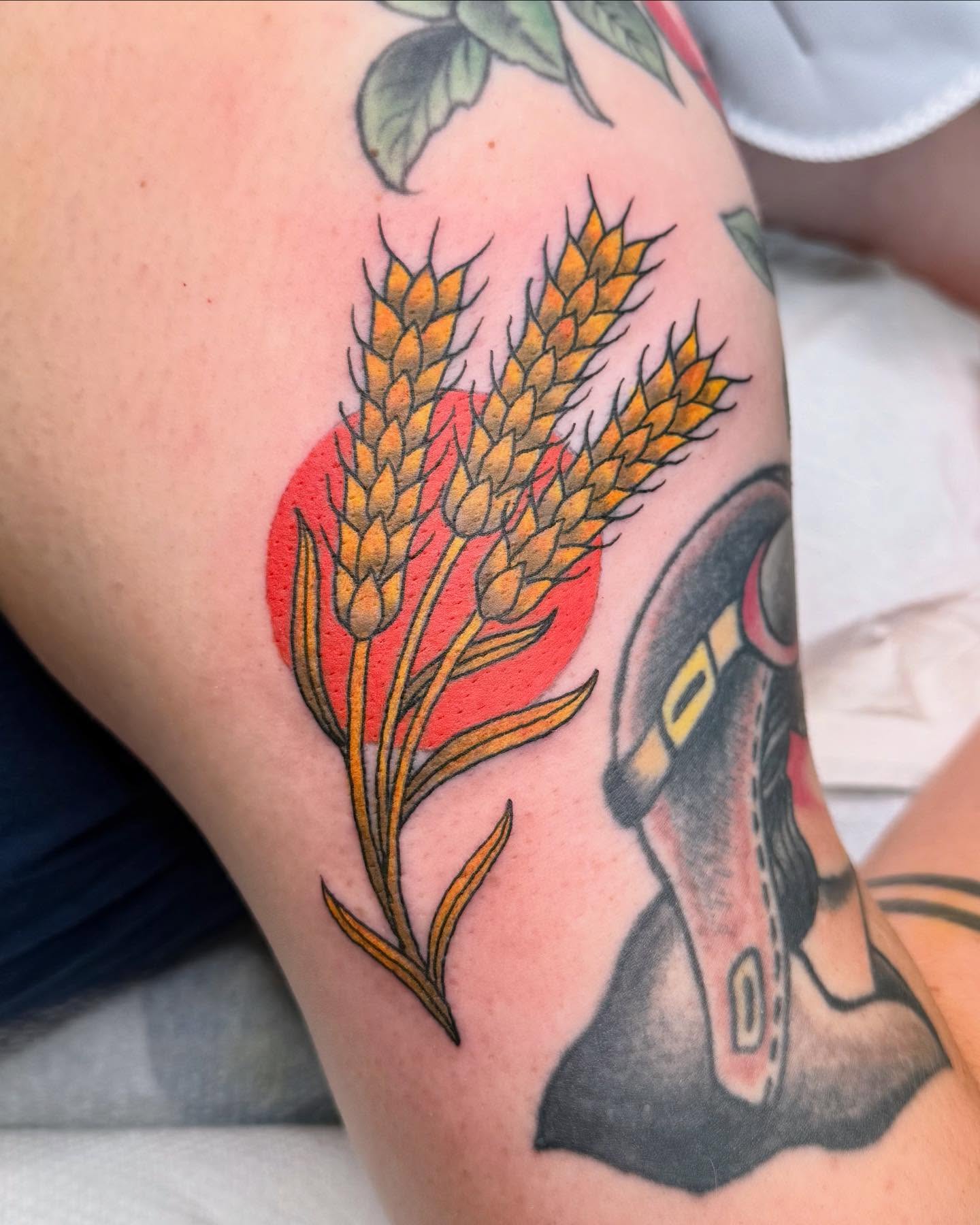 Wheat and sun American traditional tattoo on the thigh by Curtis Stairs, Seattle, Washington