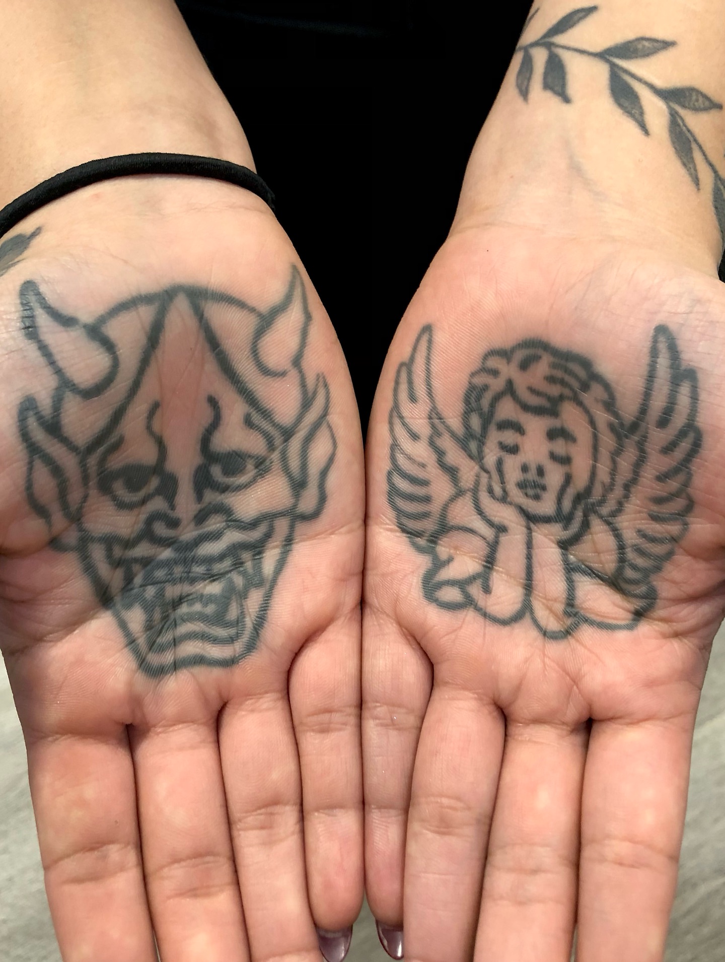 Angel and demon black and grey tattoo on the hand by Nick Sharratt, Chicago, Illinois