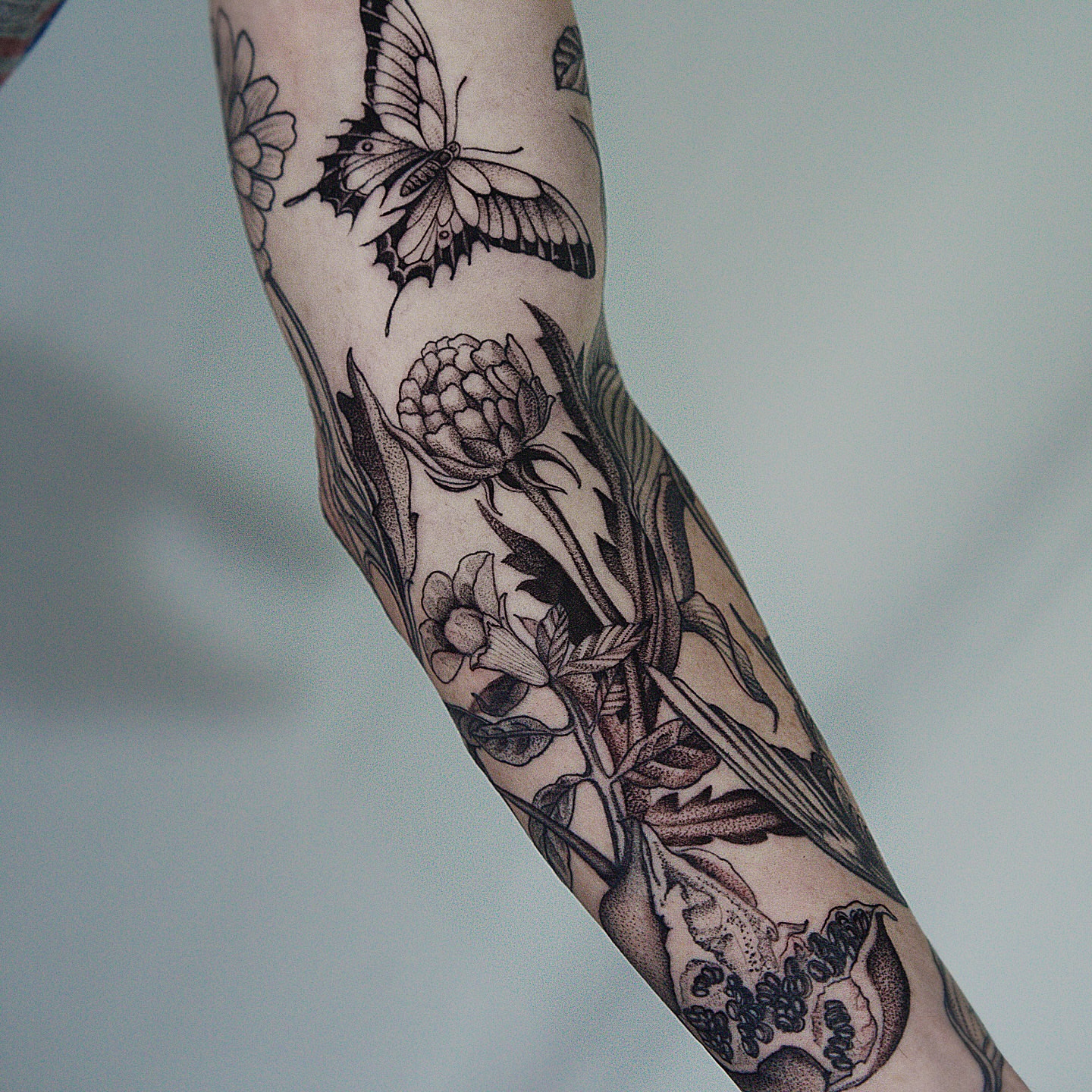 Botanical and butterfly realism tattoo on the forearm by H I R A  L U P E - tattoo artist, Oakland, California