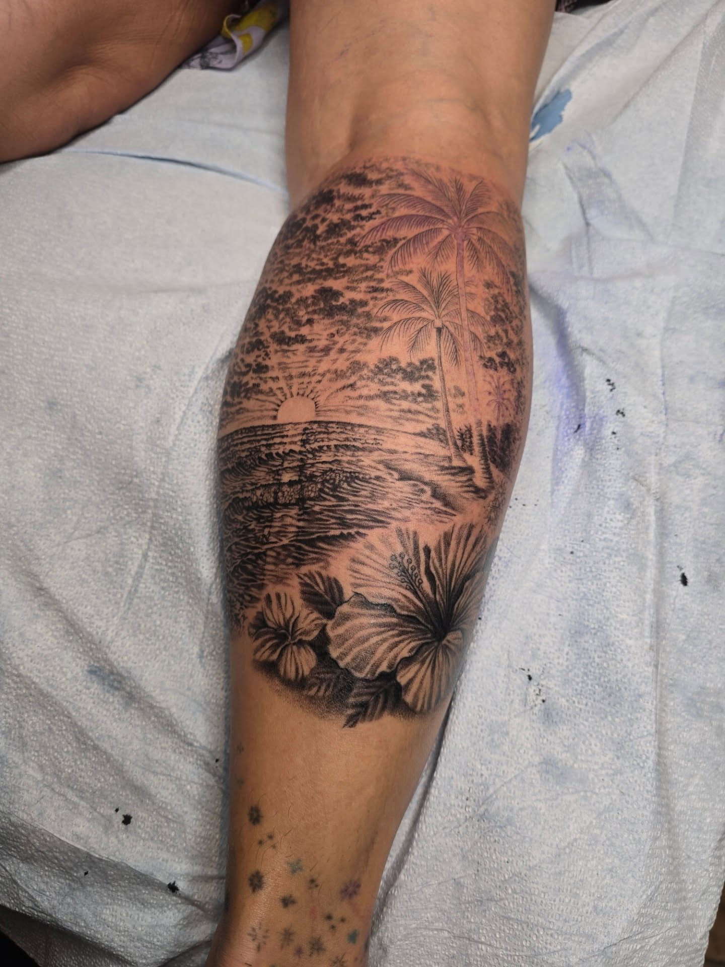 Beach sunset realism tattoo on the forearm by Anna Brittany