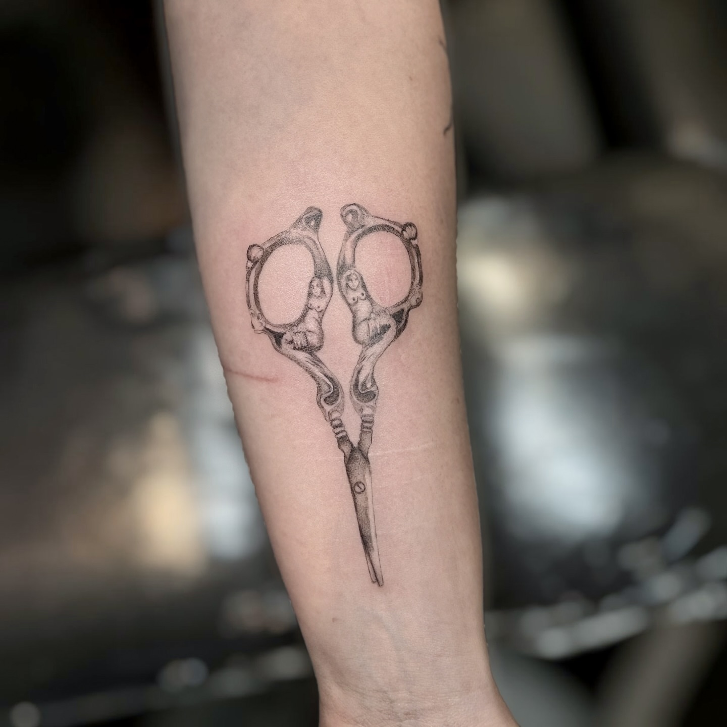 Scissors black and grey tattoo on the forearm by Raleigh tattoo artist, Raleigh, North Carolina