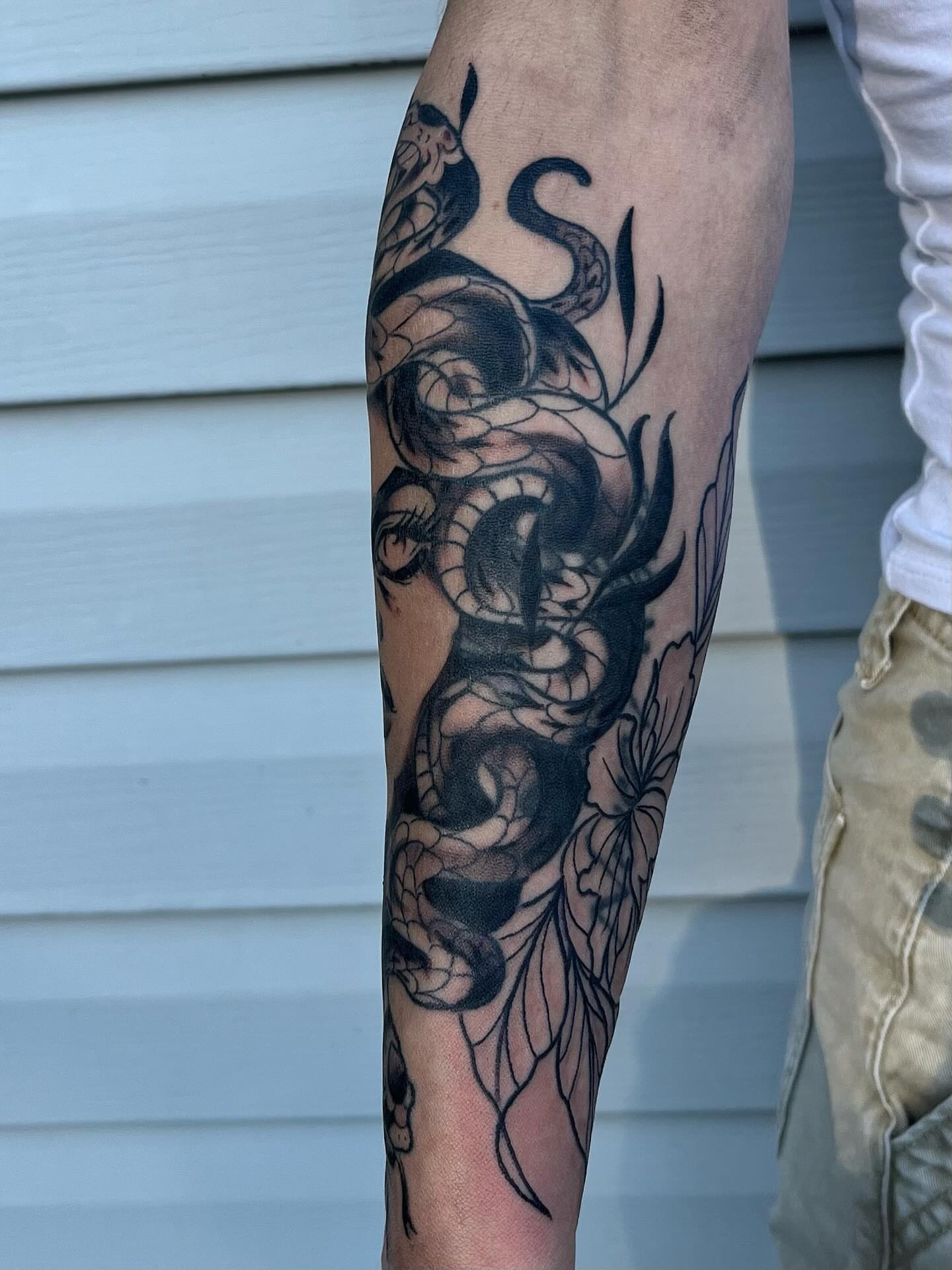 Snake and peony black and grey tattoo on the forearm by ᴴᴬᴺᴺᴬᴴ ᴿᵁᴰᴰᴱᴸᴸ