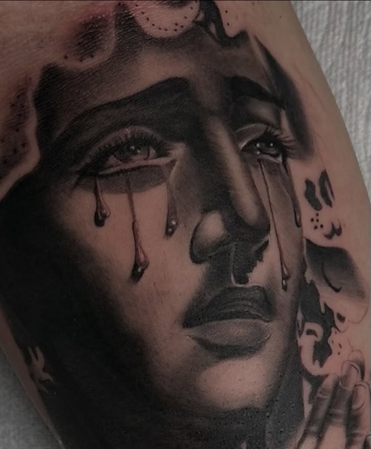 Tearful face realism tattoo on the forearm by Mando