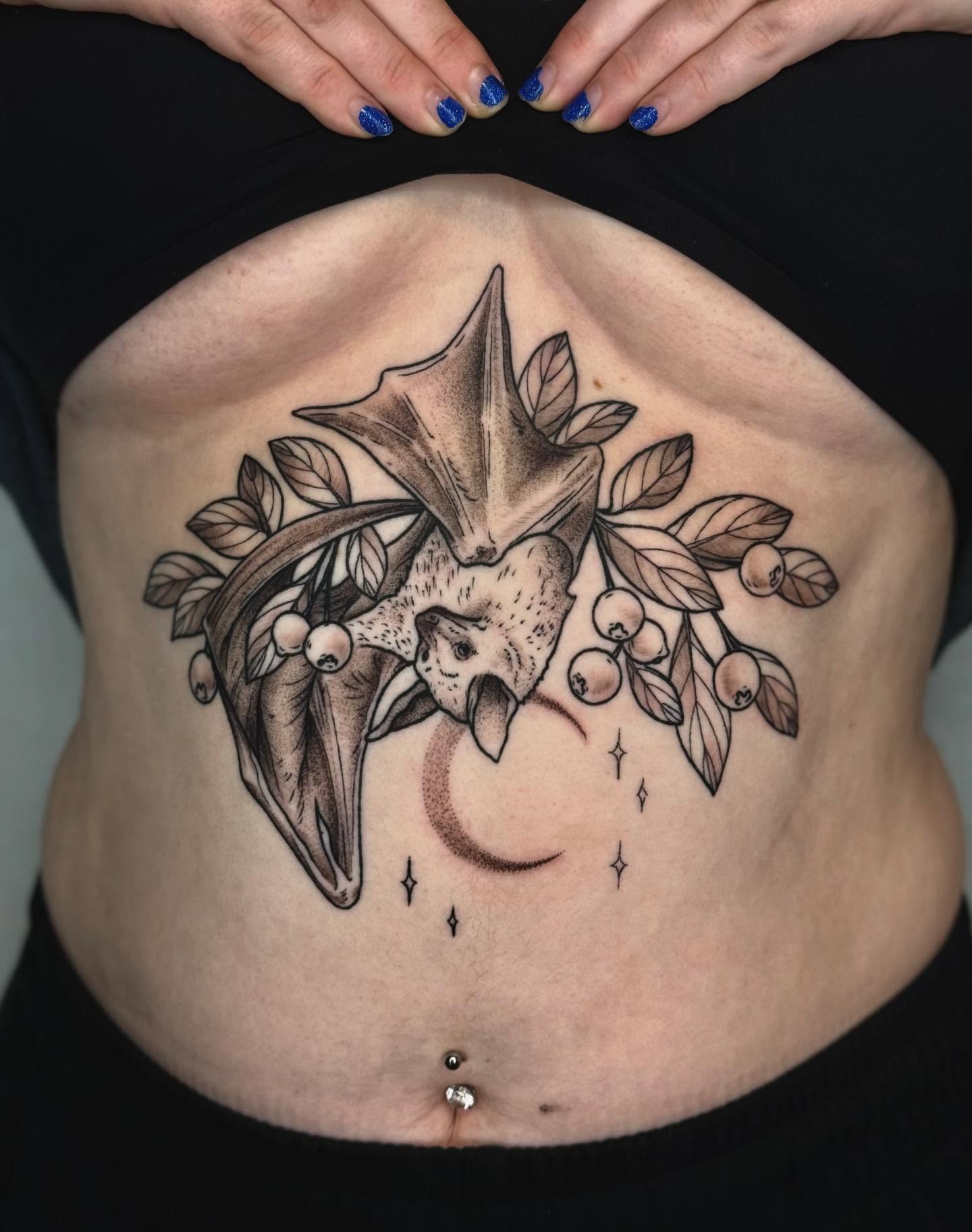Bat and berries realism tattoo on the torso by Cooper