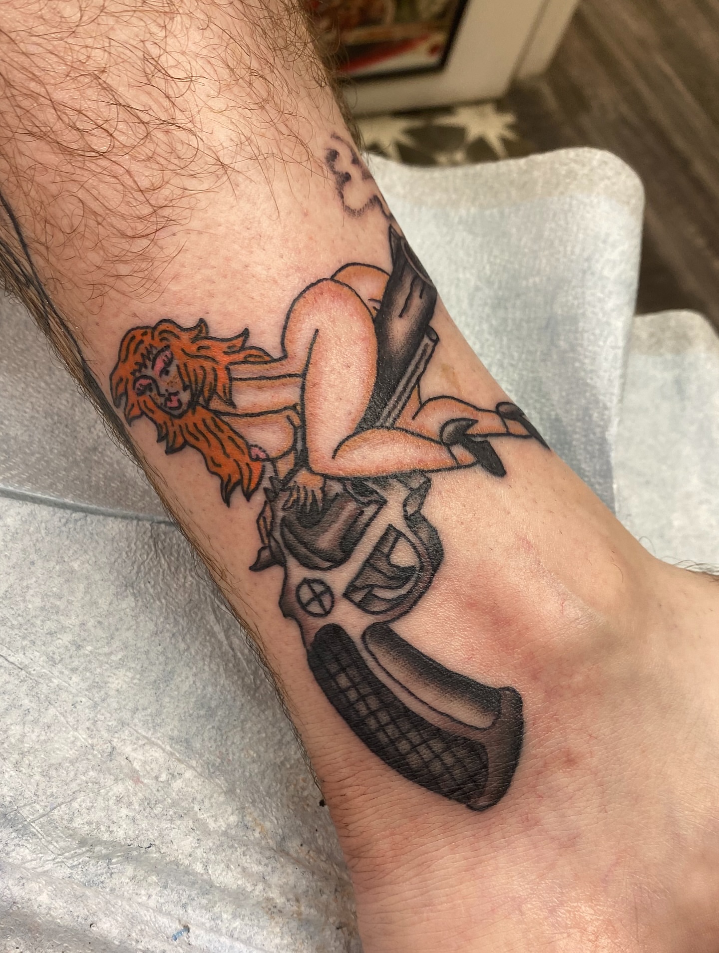 Woman riding motorcycle American traditional tattoo on the forearm by Mike Tapia