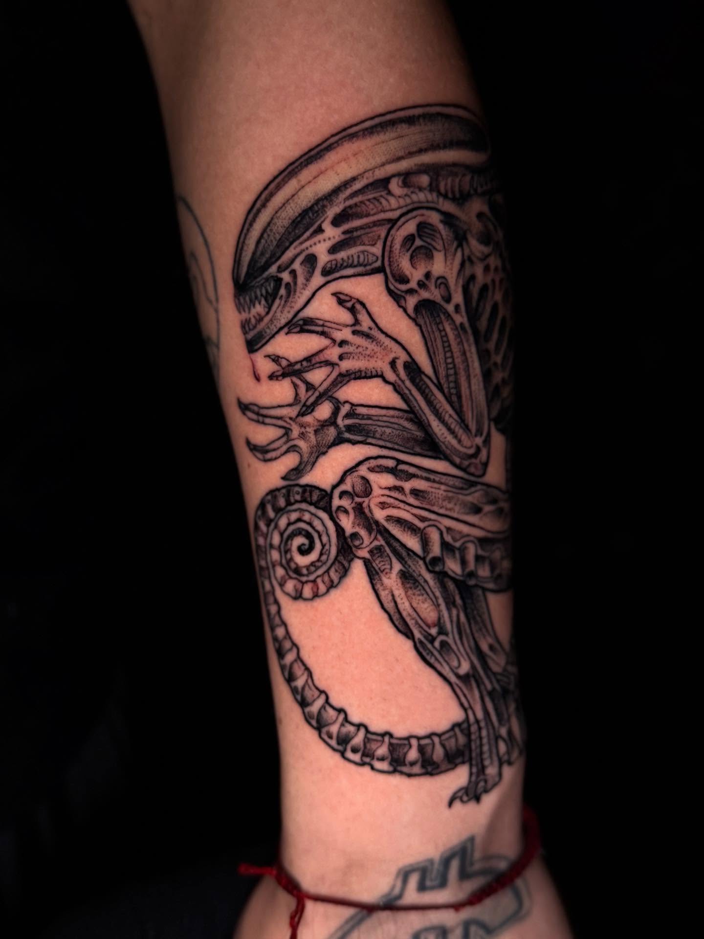 Alien creature geometric tattoo on the forearm by Thomas Martinez